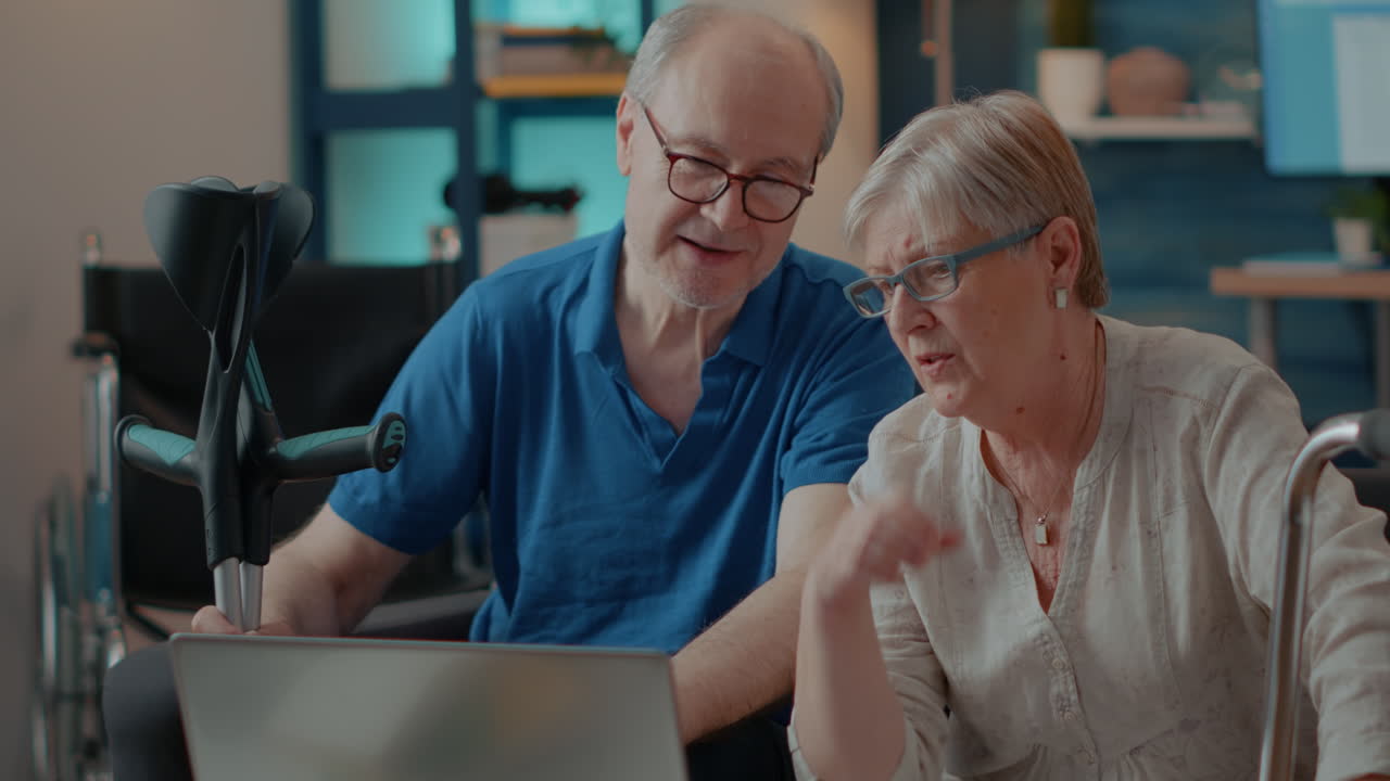 Elderly couple using laptop in assisted living
