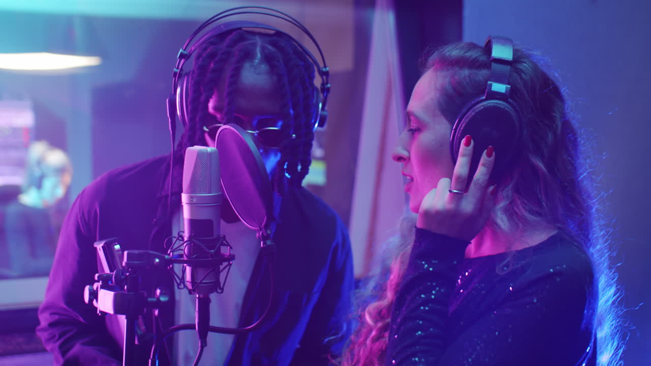 다양한 음악가 들 이 스튜디오 에서 노래 를 녹음 하고 있다