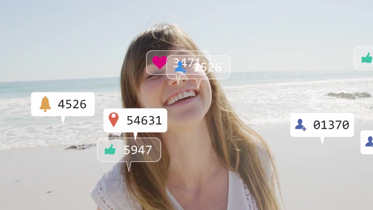 Woman facing lens smiling, laughing at beach, reacting to social media bubbles appearing from right