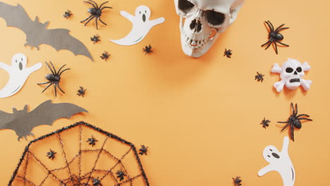 close up of multiple halloween toys with copy space against orange background