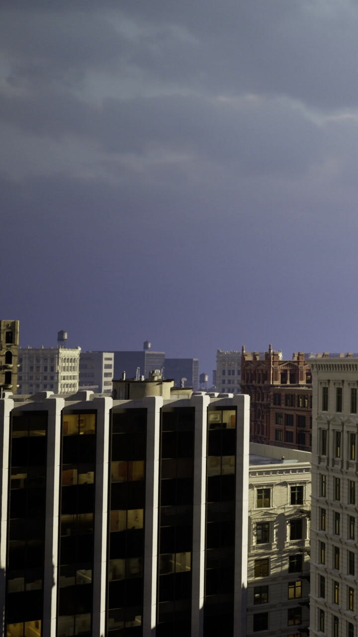 City skyline with buildings under a cloudy sky during early evening