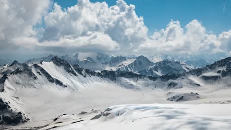 vuelo aéreo a través de nubes montañosas sobre hermosos picos nevados de montañas y glaciares.