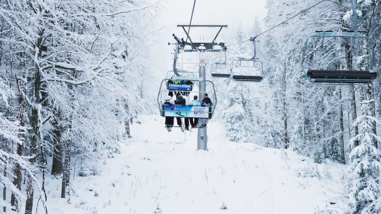 Ski lift in winter forest with snow