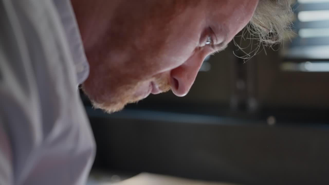 Investigator, agent, or spy leans over a cluttered office desk, using a magnifying glass to examine secret papers. The scene suggests close inspection, intelligence gathering, and hidden truths. crime