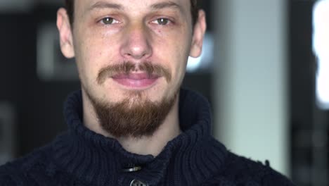 close up tight shot of a young man looking and yawning to the camera