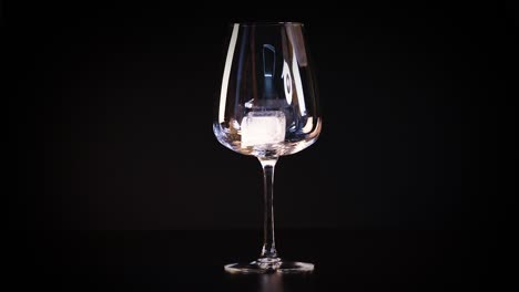 ice cube placed into an empty glass