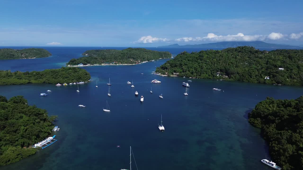 Filmato aereo di piccole isole tropicali a Puerto Galera, nelle Filippine, circondate da acque turchesi e da una fitta foresta verde, che creano una scena naturalistica incontaminata, perfetta per viaggi e immersioni