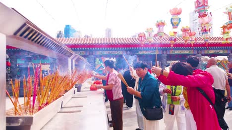 people offering incense at hong kong temple