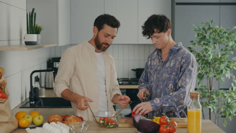 happy couple cooking salad together