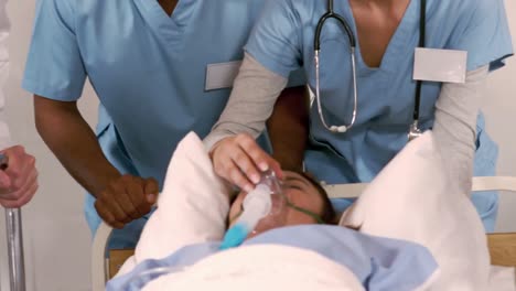 patient receiving oxygen mask from medical team