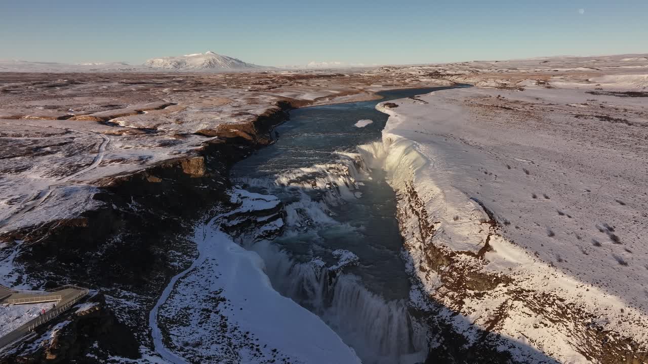Aerial - Gullfoss waterfall plunging through snowy Hvítá canyon in Iceland