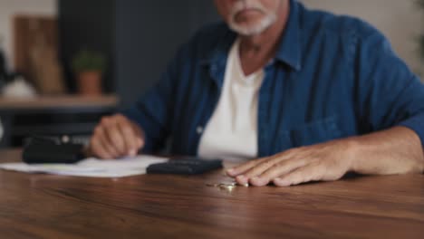 broken senior caucasian man counting rest of his money and feeling depressed.