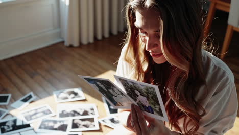 woman looking at old family photos
