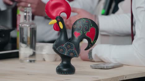 traditional black portuguese rooster figurine with red heart details on a table