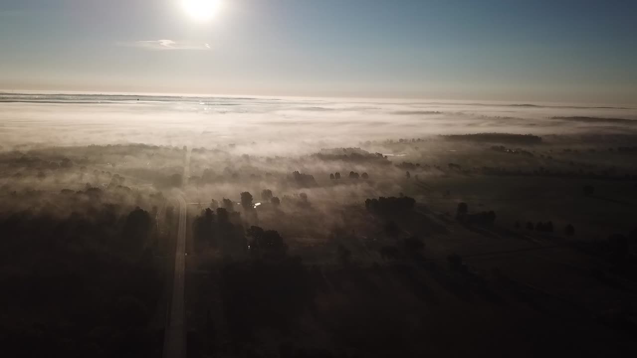 Aerial shot above the trees and fog in the rural Missouri Ozarks