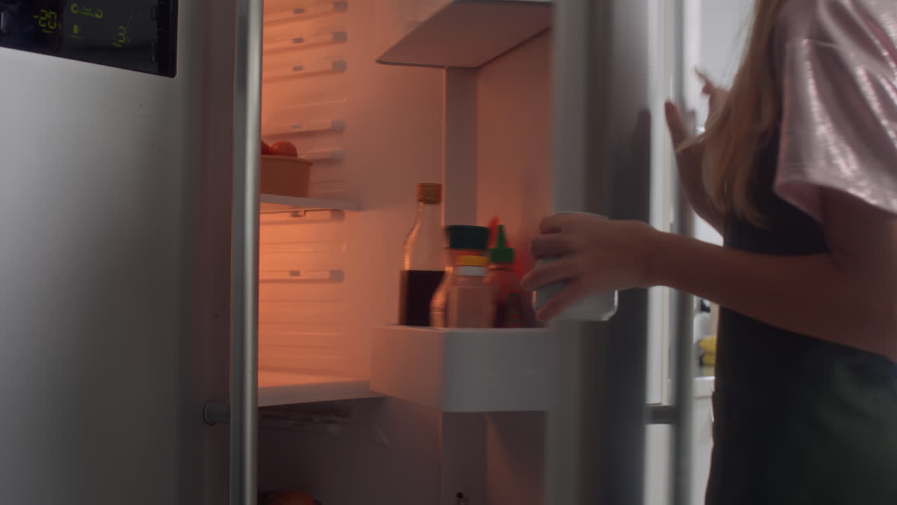Unrecognizable Girl Taking Dairy Cream from Fridge at Kitchen