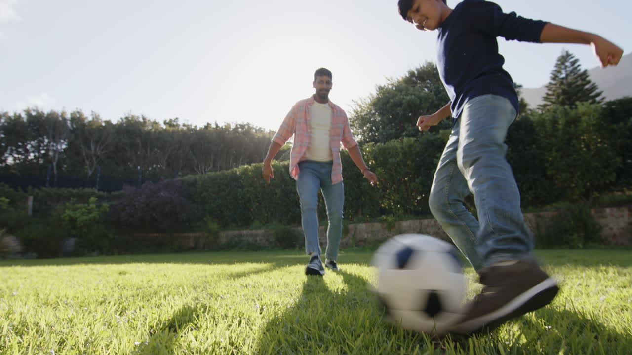 Running in park, Indian father and young son enjoying outdoor activity together