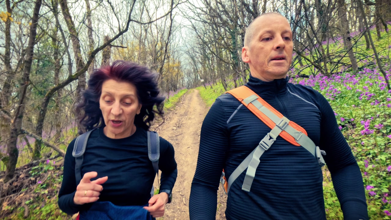 Authentic couple performing light physical activity in nature. Concept of cardiovascular health, hypertension prevention, and healthy lifestyle for middle aged people.