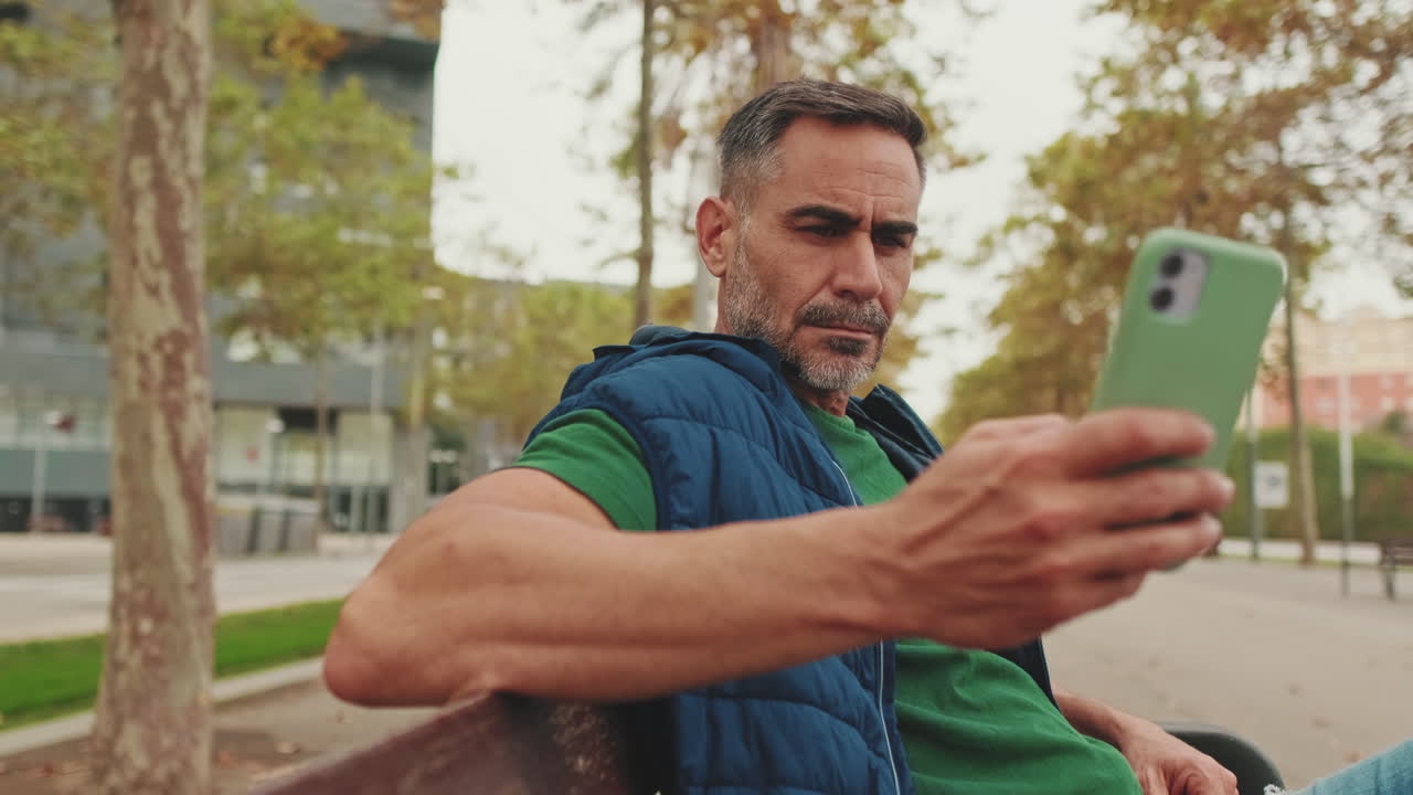 Man using smartphone in park