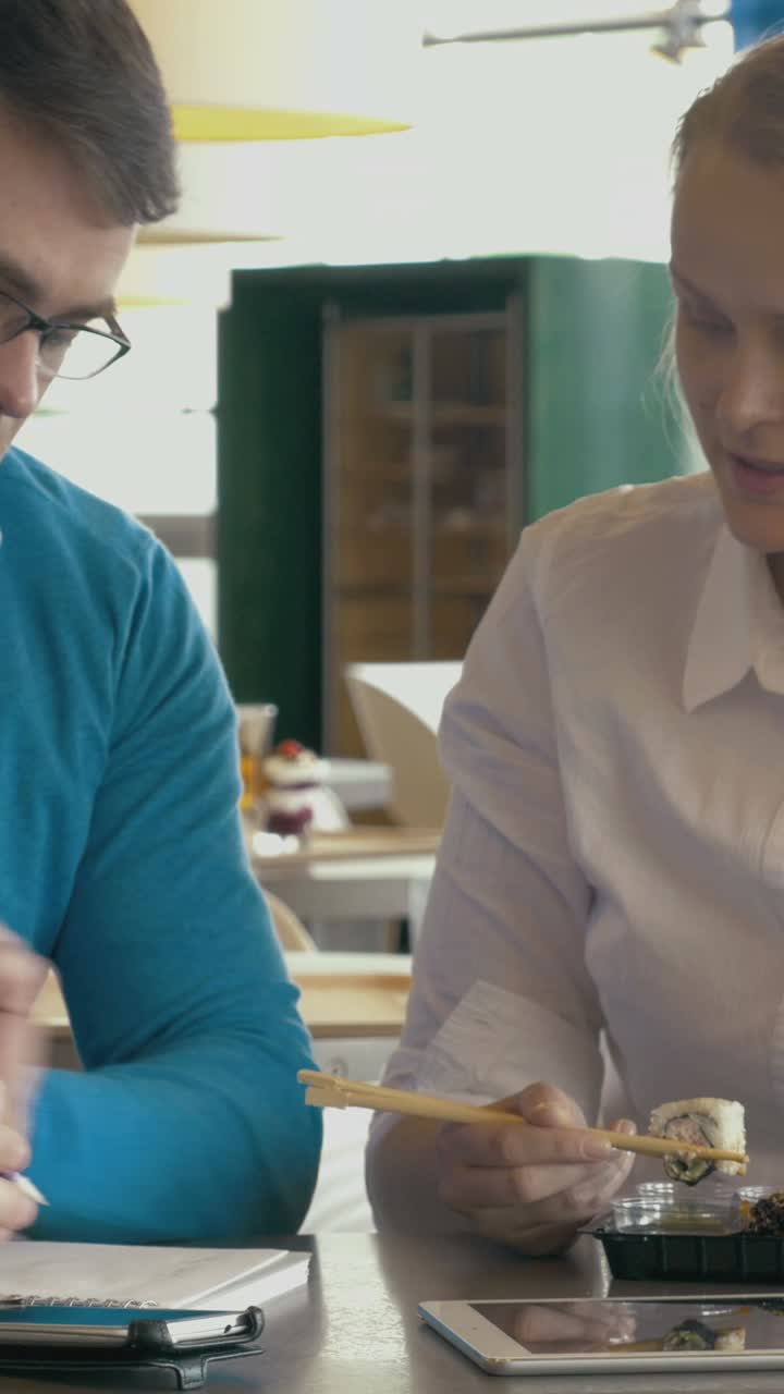 Business lunch meeting with sushi and technology