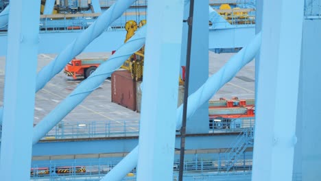 hydraulic lifts carefully transferring goods at shipping port terminal