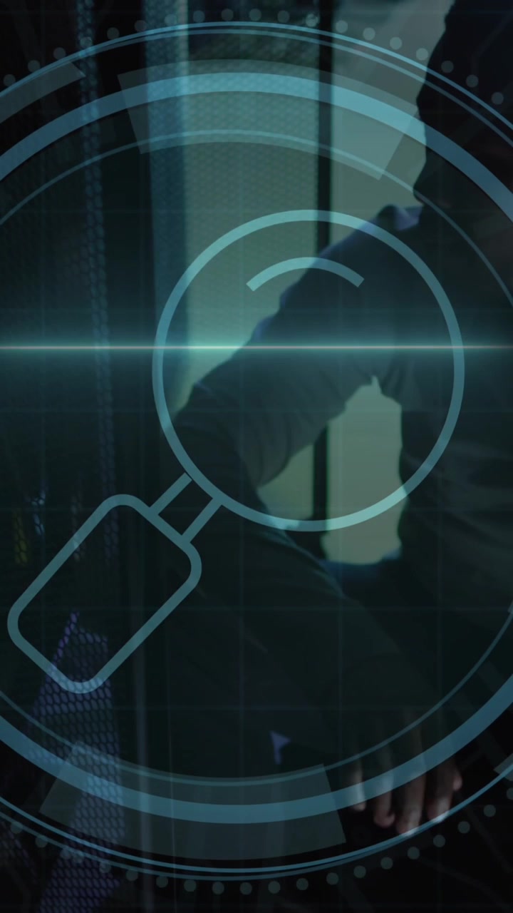 Animation of magnifying glass scanner over african american male engineer working at server room