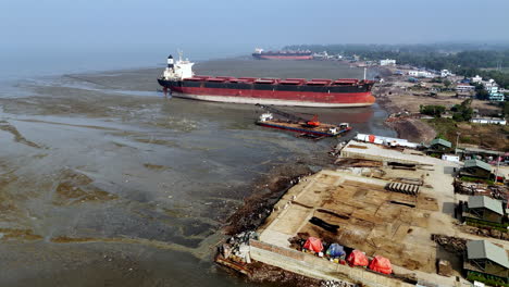 cinematic epic revealing shot of a large ship graveyard in bangladesh.