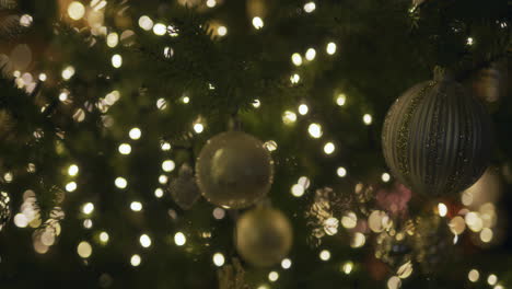 details of a christmas tree with baubles and twinkling lights