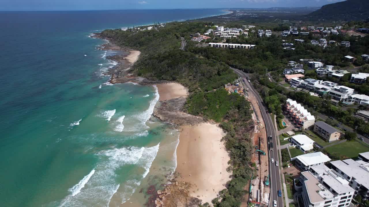 Waves In The Sandy Shore Of Coolum Beach In Summer With Coastal Road And Buildings In QLD, Australia. - aerial shot