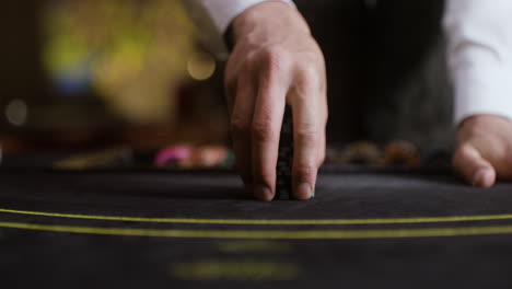 croupier collecting poker chips.