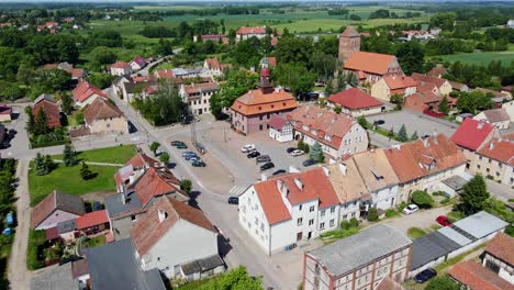 scenic srokowo village square, red-roofed buildings nestled, lush polish nature