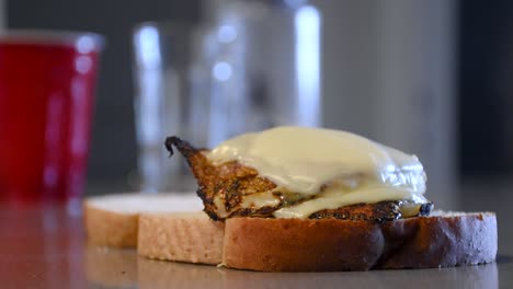 serving tasty fried egg with cheese on top off a slice of white bread toast.
