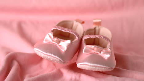 Pink-booties-falling-on-pink-blanket