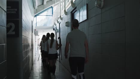 female hockey players going out of dressing room