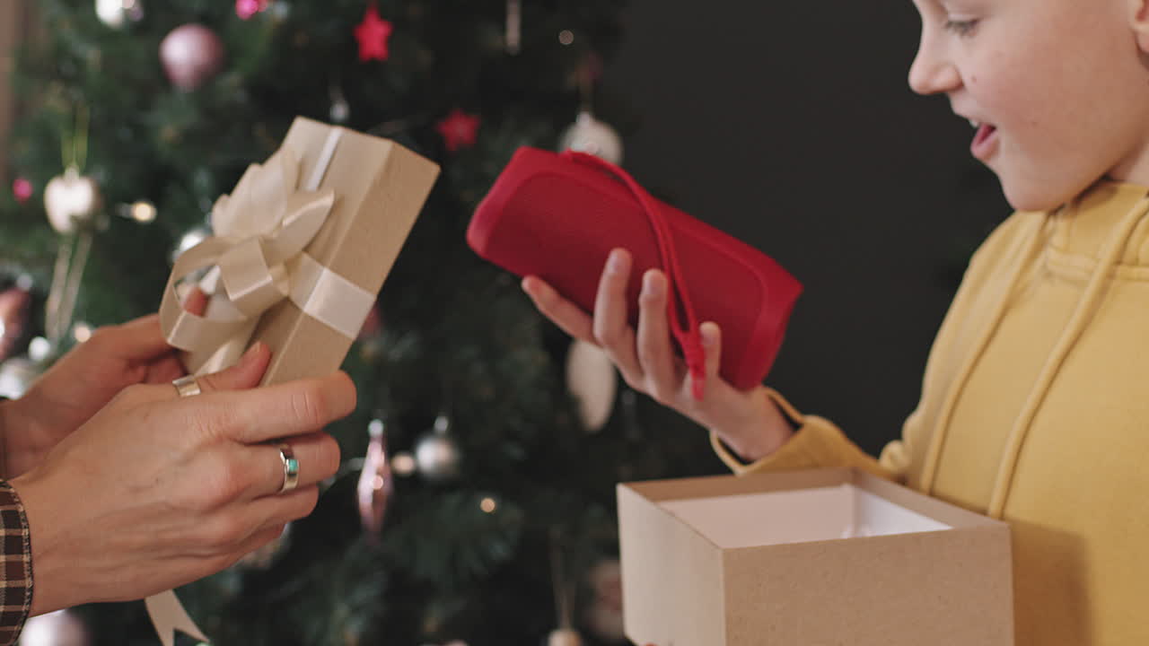 Mother Giving Gift Box to Son on Christmas
