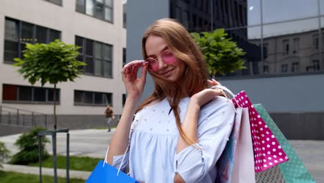 student teen girl with shopping bags. good black friday holiday sale discounts, low price purchases