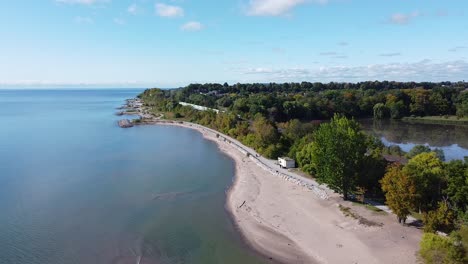 commuter train on railway tracks along lake ontario waterfront shoreline