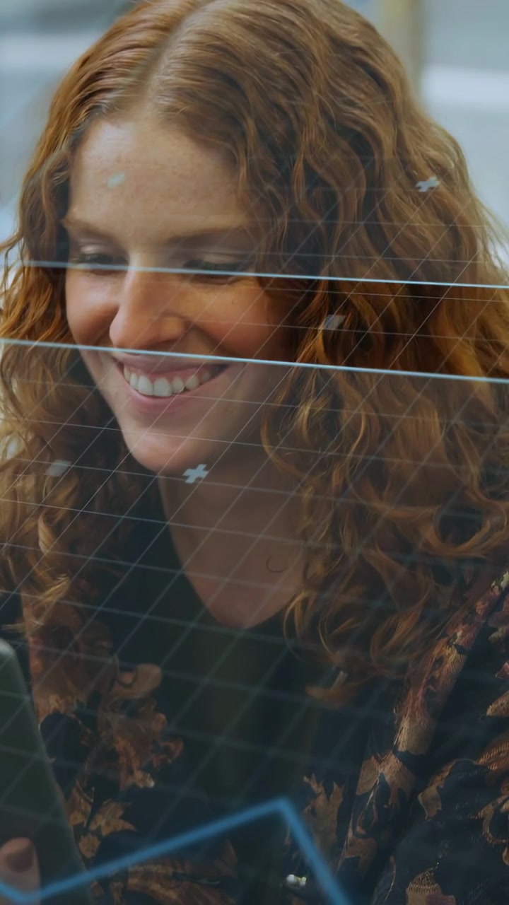 Vertical video: Woman tapping phone behind transparent partition, business overlay tracking smile
