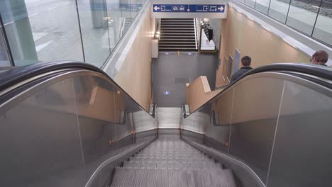 passengers descend the stairs instead of taking the escalator in the railway station of leuven, belgium