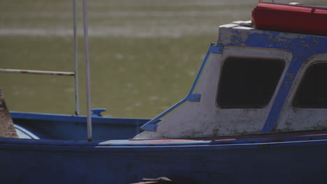 Close-up-Of-An-Old-Boat-With-Paint-Peeling-Off-From-Its-Wooden-Hull