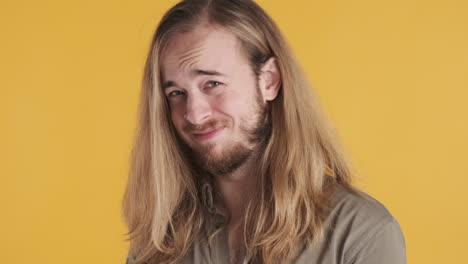 caucasian young man looking skeptical in front of the camera.