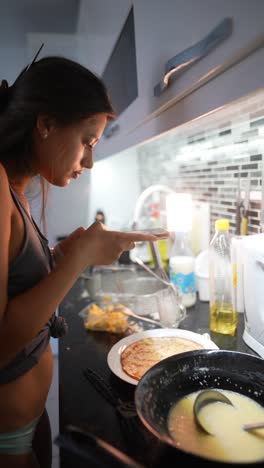 woman cooking pancakes at home