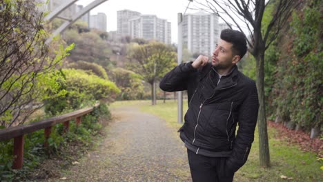 Pensive-man-walking-in-the-city,-thoughtful-walking-in-the-city-park.