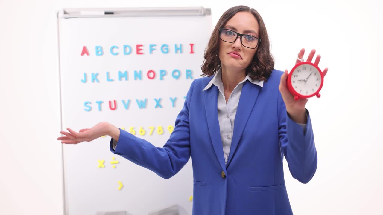 Teacher with clock in classroom