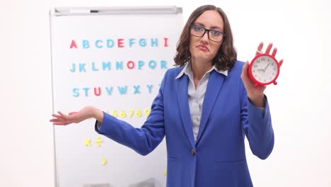 teacher with clock in classroom