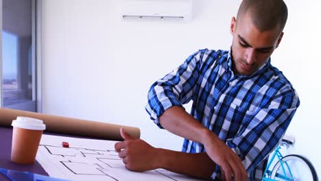 male architect working on blueprint over drafting table 4k