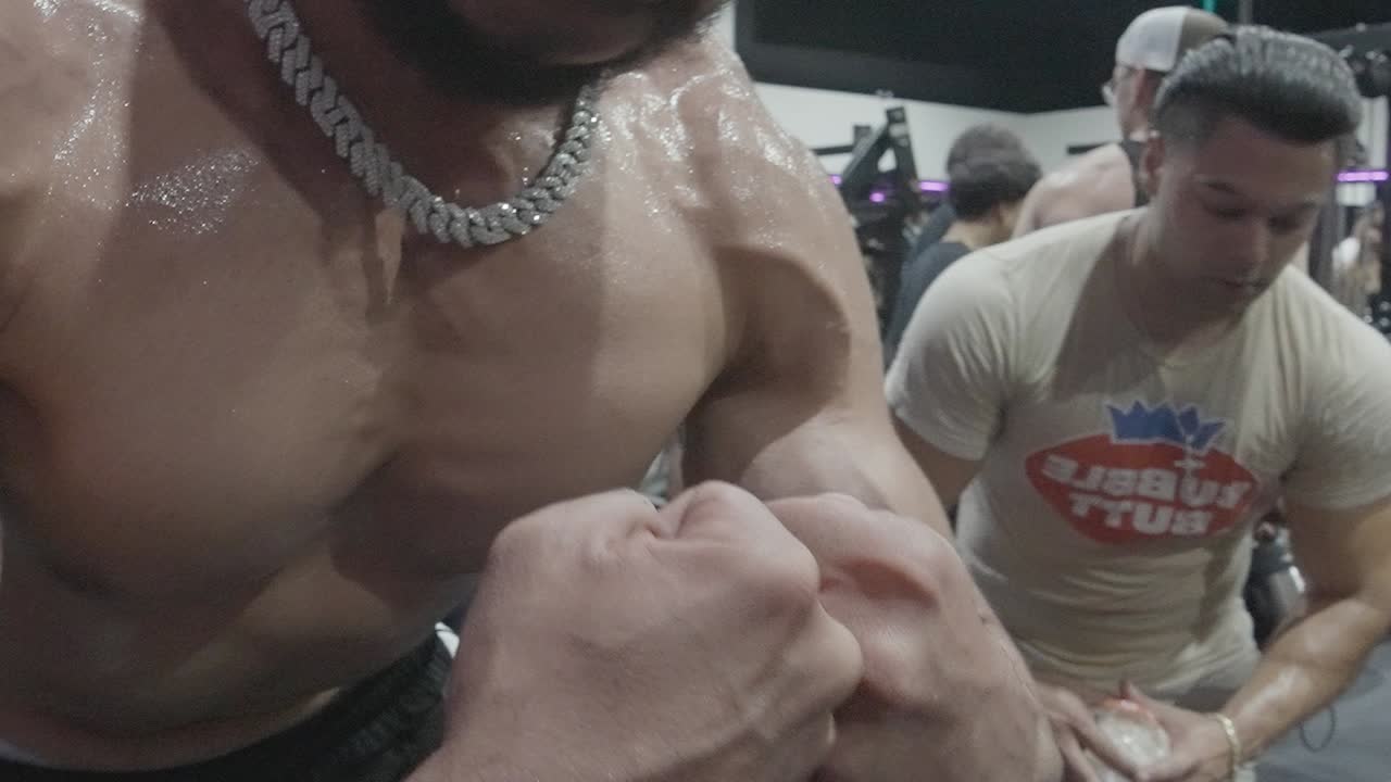 Muscular Man Works Out in the Gym