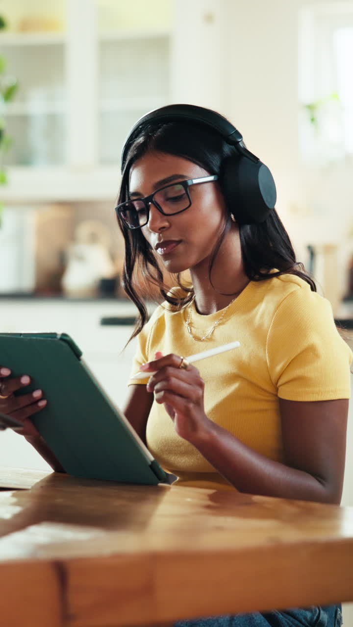 Woman using tablet with headphones