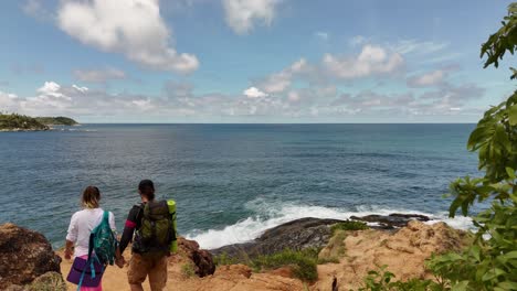 couple hiking on coastal trail with ocean view