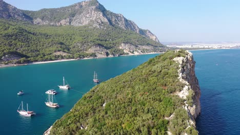 Aerial-View-of-Anchored-Boats-by-Islet-and-Scenic-Coastline-on-Mediterranean-Sea